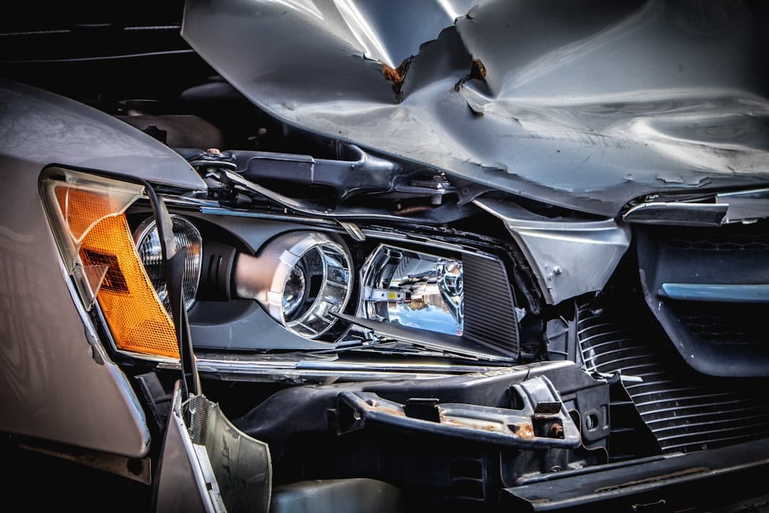 Damaged car with crushed hood after a collision