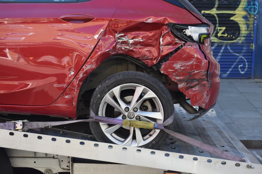 Damaged car being towed after a road traffic collision
