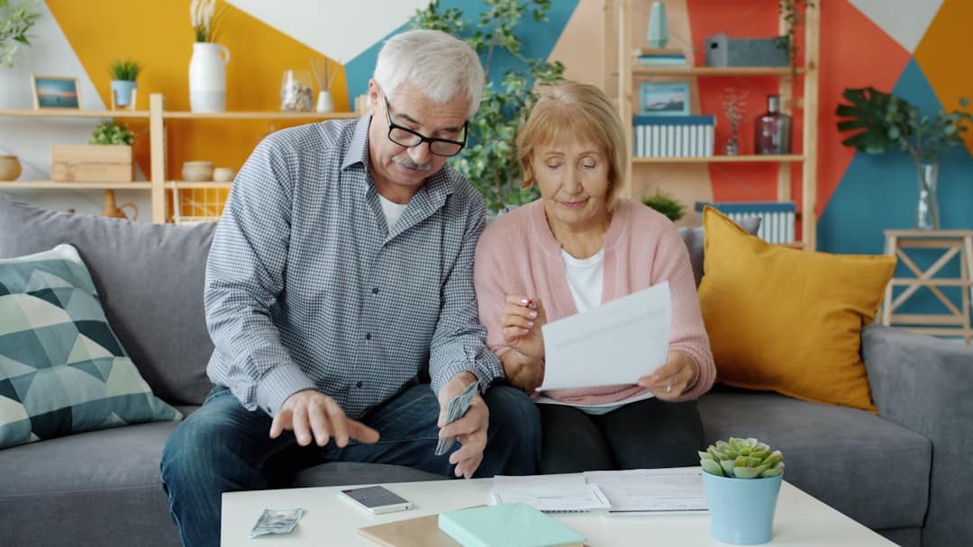 Senior couple reviewing documents together at home, representing advance directive planning