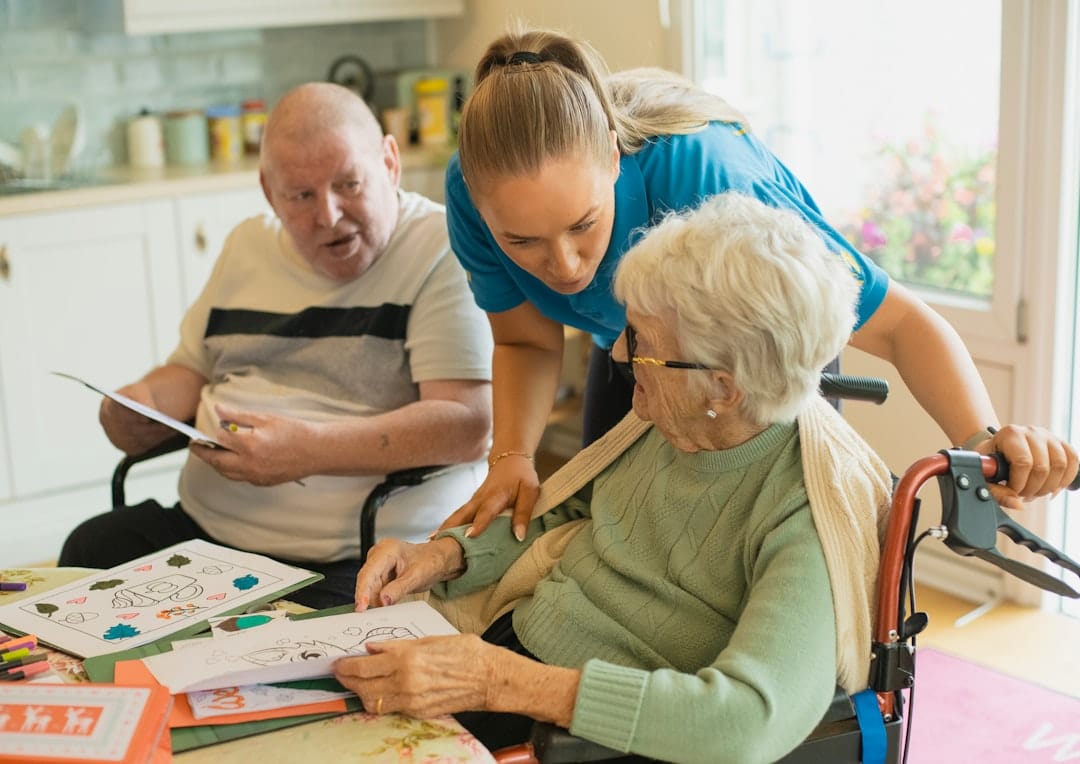 Caregiver assisting an elderly couple, representing guardianship arrangements
