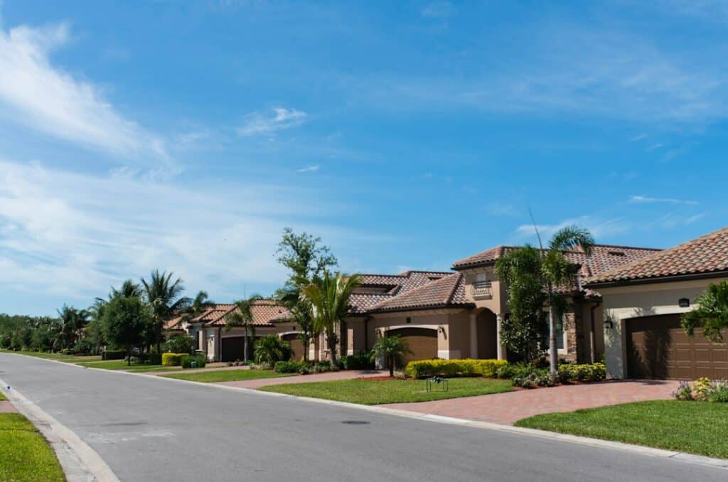 A Florida suburban street with houses and palm trees