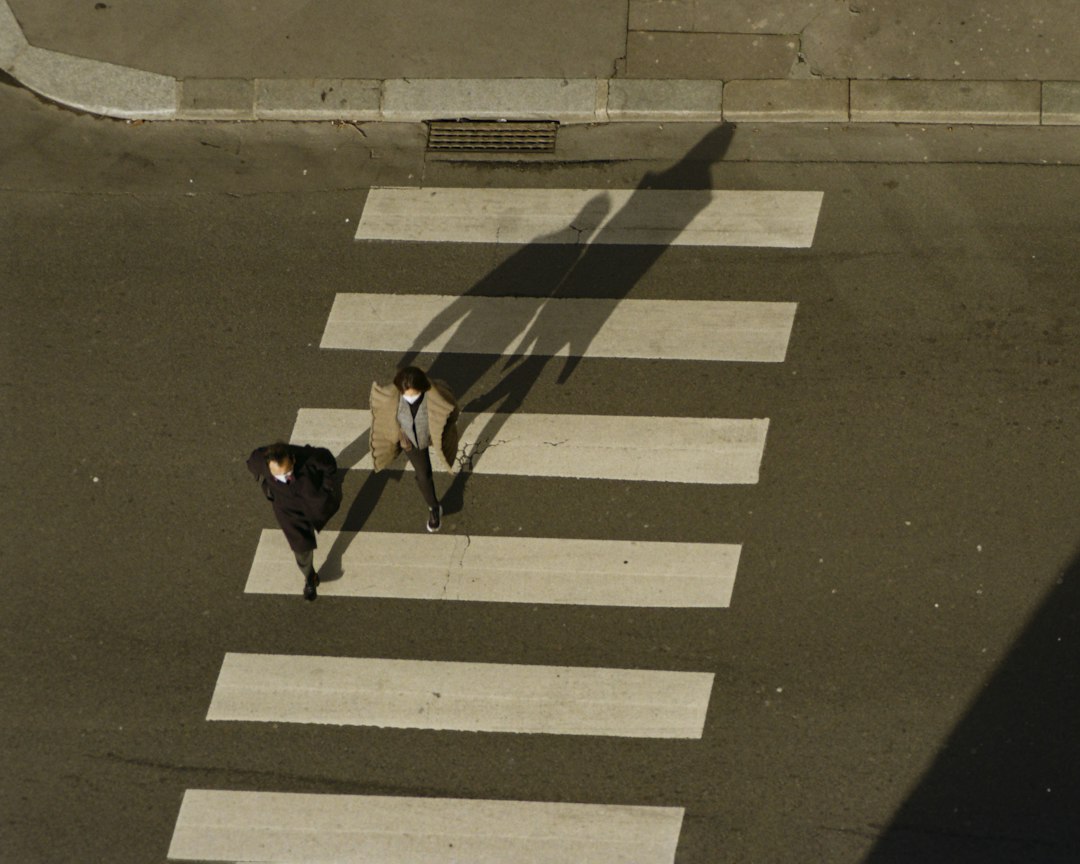Pedestrians walking across a crosswalk in the city